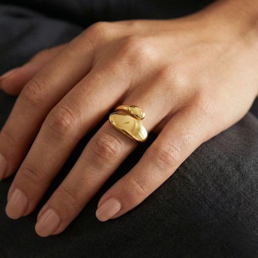 Embrace the peak of modern sculptural design with this impeccably crafted gold-toned open ring. Featuring a masterclass in organic fluidity and high-mirror light play, this piece offers a sophisticated "liquid gold" silhouette that serves as the ultimate statement of contemporary elegance.